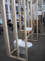 This photograph shows the Milwaukee Idea Home bathroom layout. The location of the toilet and the sink are featured in the bathroom showing an accessible toilette that is low to the ground and a sink with space beneath for use while seated.