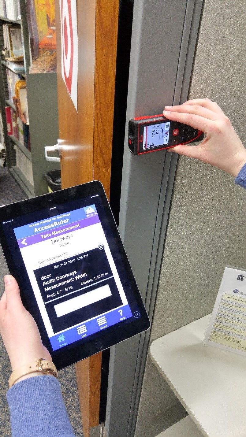 Practitioner measuring doorframe distance using iPad camera in order to determine accessibility of doorway.