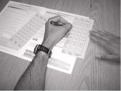 A black and white image of an SFA-AT flap placed correctly over an SFA page and being written on